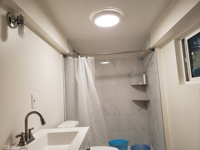 bathroom featuring toilet, vanity, and a shower with shower curtain