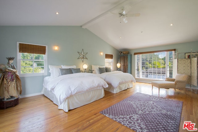 bedroom featuring light hardwood / wood-style flooring, lofted ceiling with beams, and ceiling fan