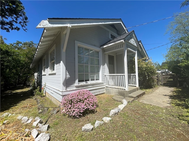 view of side of home featuring a porch