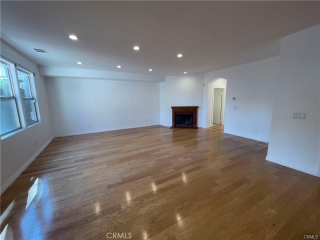 unfurnished living room featuring hardwood / wood-style flooring