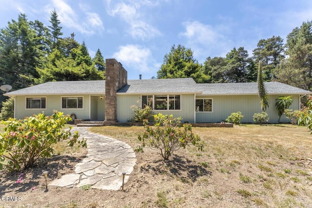 back of property with a chimney