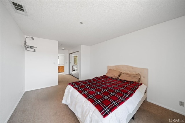 carpeted bedroom featuring a textured ceiling