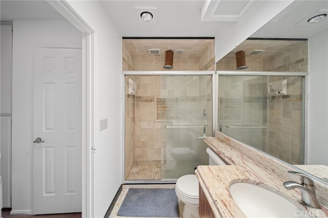 bathroom featuring vanity, toilet, and an enclosed shower