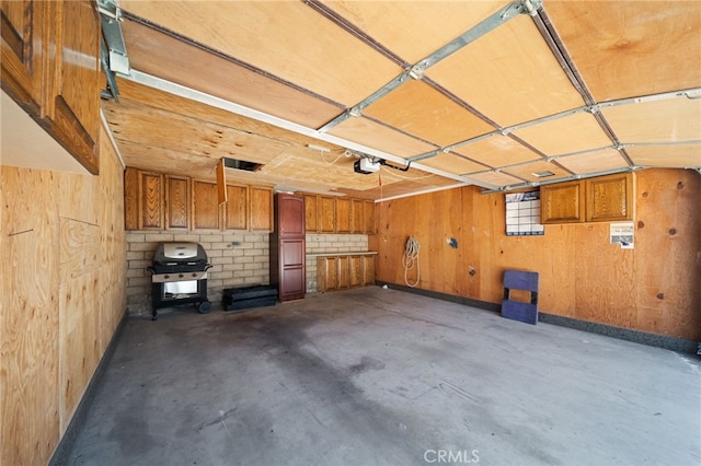 43195 Andrade Ave Unit S, Hemet, CA 92544 - garage with wood walls and a garage door opener