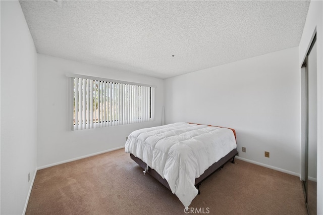 bedroom with carpet floors and a textured ceiling