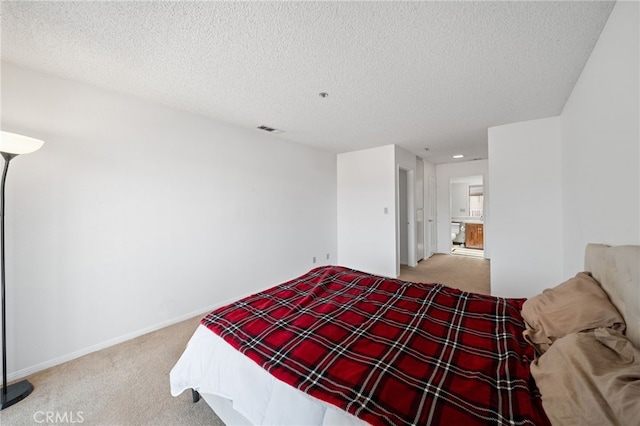 carpeted bedroom featuring a textured ceiling