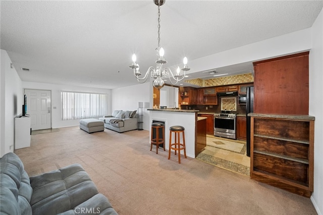 carpeted living room with a textured ceiling and a chandelier