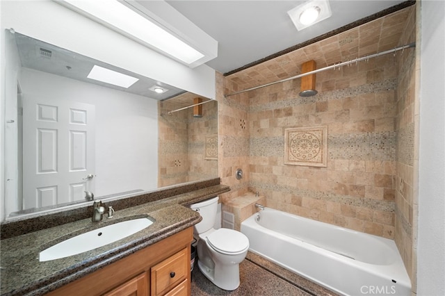 full bathroom with tiled shower / bath combo, vanity, and toilet