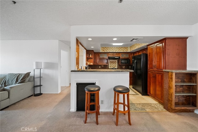 43195 Andrade Ave Unit S, Hemet, CA 92544 - kitchen with light colored carpet, open shelves, black appliances, a peninsula, and open floor plan