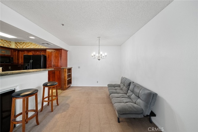 interior space featuring light carpet, a notable chandelier, and a textured ceiling