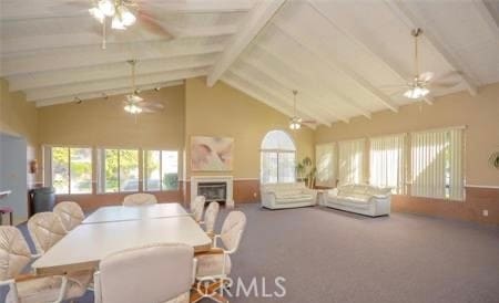 dining room with high vaulted ceiling, ceiling fan, beamed ceiling, and carpet flooring