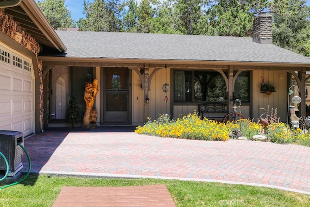 property entrance with covered porch and a garage