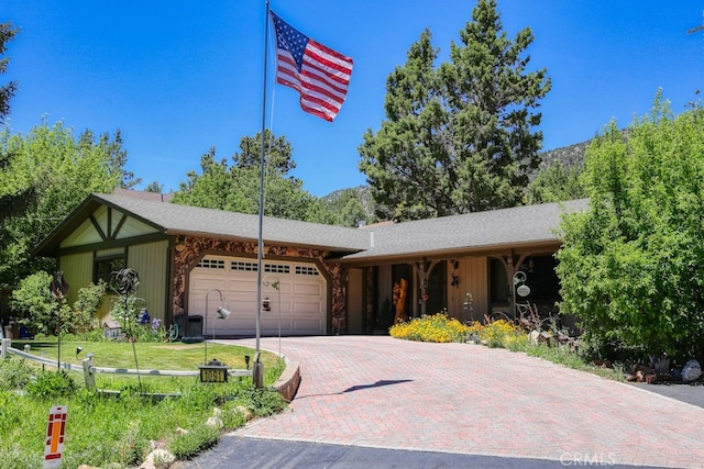 ranch-style home featuring a front yard and a garage