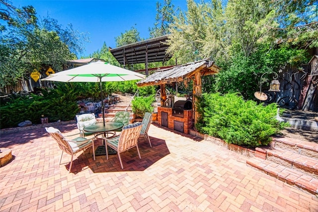 view of patio with area for grilling, a pergola, and grilling area