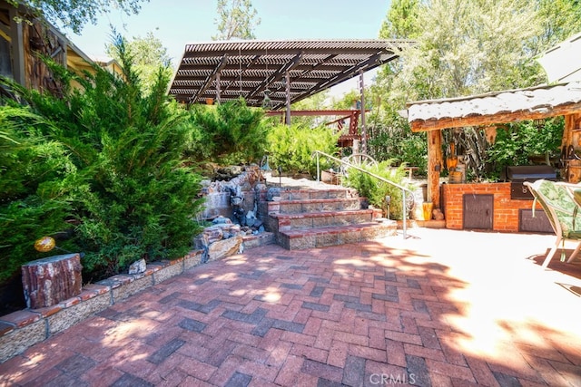 view of patio featuring an outdoor kitchen, area for grilling, and a pergola