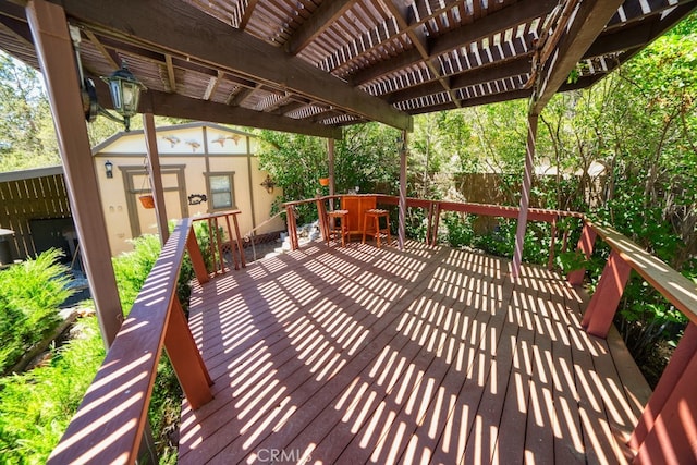 deck featuring a pergola and an outdoor structure