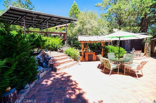 view of patio featuring an outdoor kitchen and a pergola