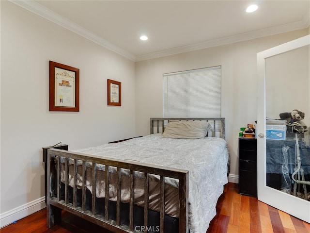 bedroom with dark hardwood / wood-style floors and crown molding