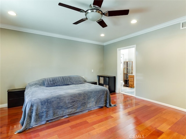 bedroom with crown molding, ceiling fan, hardwood / wood-style flooring, and ensuite bathroom