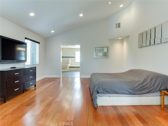 bedroom with light hardwood / wood-style flooring, multiple windows, and high vaulted ceiling