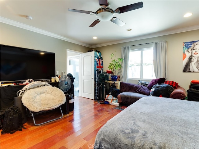 bedroom featuring ornamental molding, ceiling fan, and hardwood / wood-style flooring