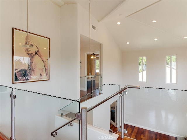 hall featuring vaulted ceiling and hardwood / wood-style flooring