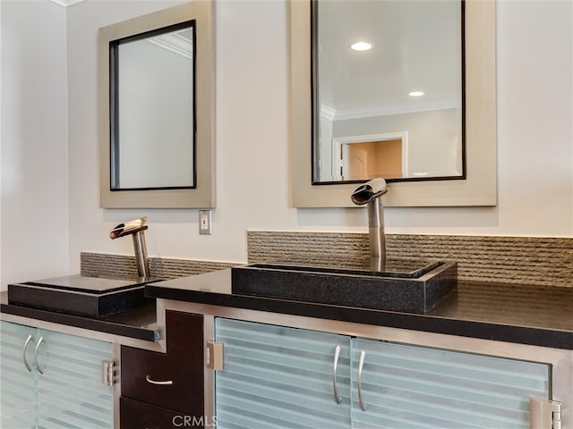 interior space with ornamental molding and sink