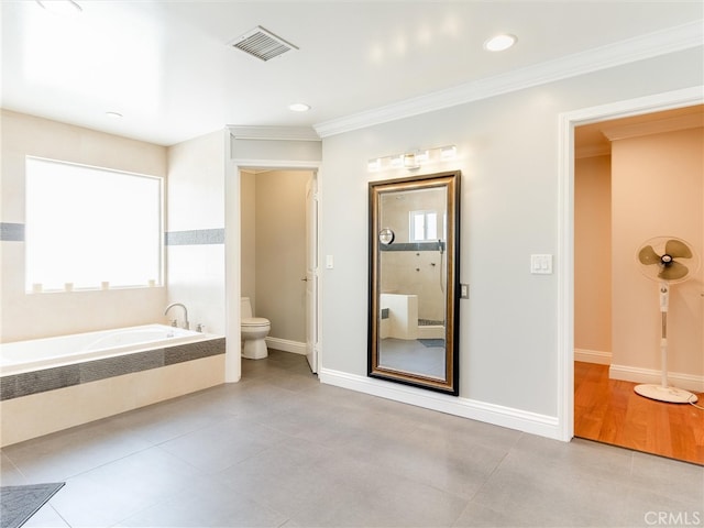 bathroom featuring ornamental molding, tile patterned flooring, a bath, and toilet