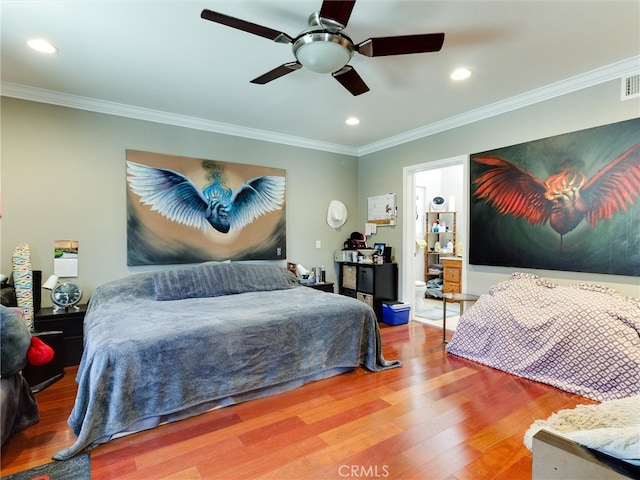 bedroom featuring wood-type flooring, ornamental molding, and ceiling fan