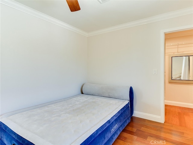 bedroom featuring crown molding, ceiling fan, and hardwood / wood-style flooring