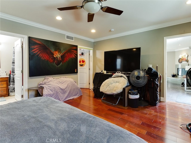 bedroom with wood-type flooring, crown molding, ensuite bathroom, and ceiling fan