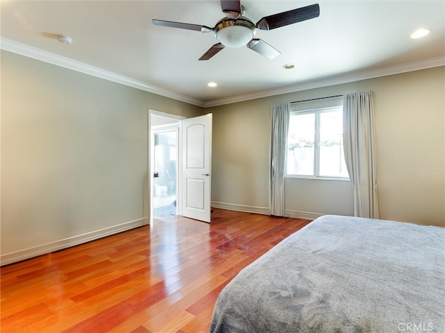 bedroom featuring ceiling fan, ornamental molding, and light hardwood / wood-style floors