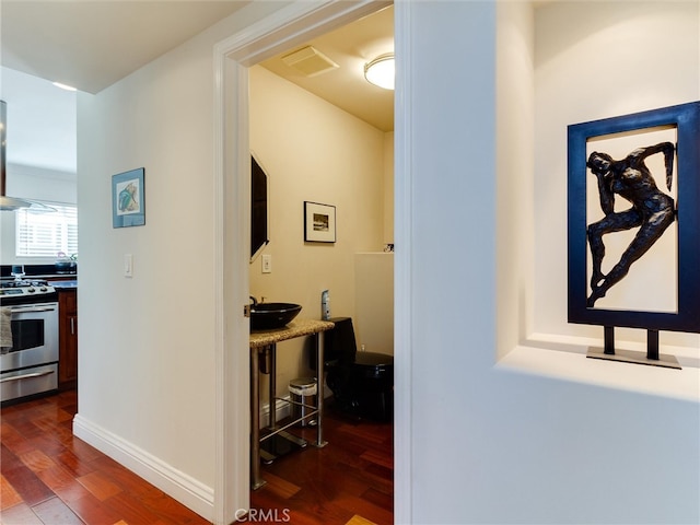 corridor with dark hardwood / wood-style flooring