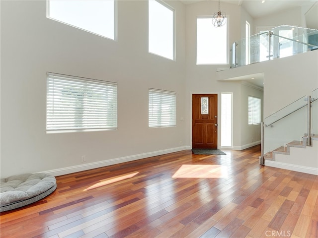 entrance foyer featuring a towering ceiling and a healthy amount of sunlight