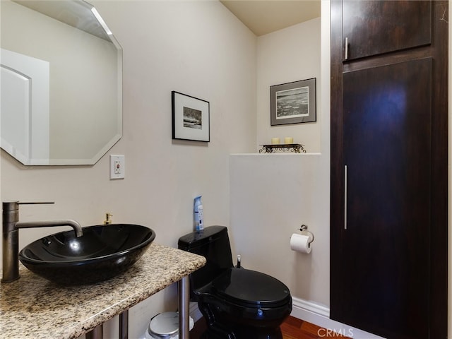 bathroom featuring hardwood / wood-style flooring, sink, and toilet