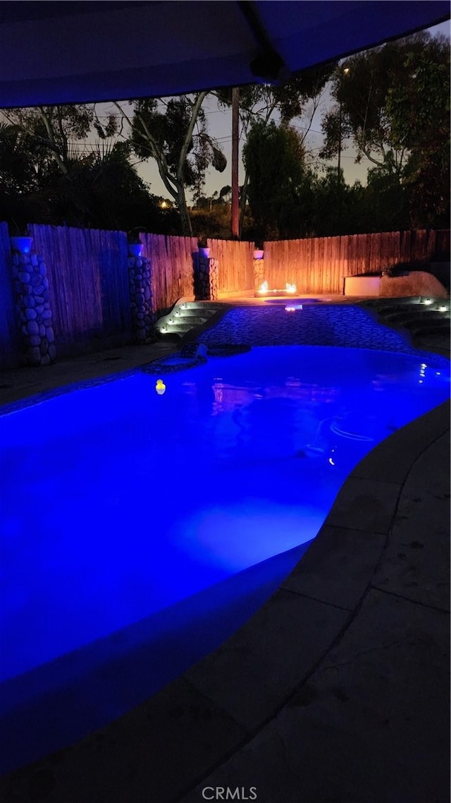 view of pool at dusk