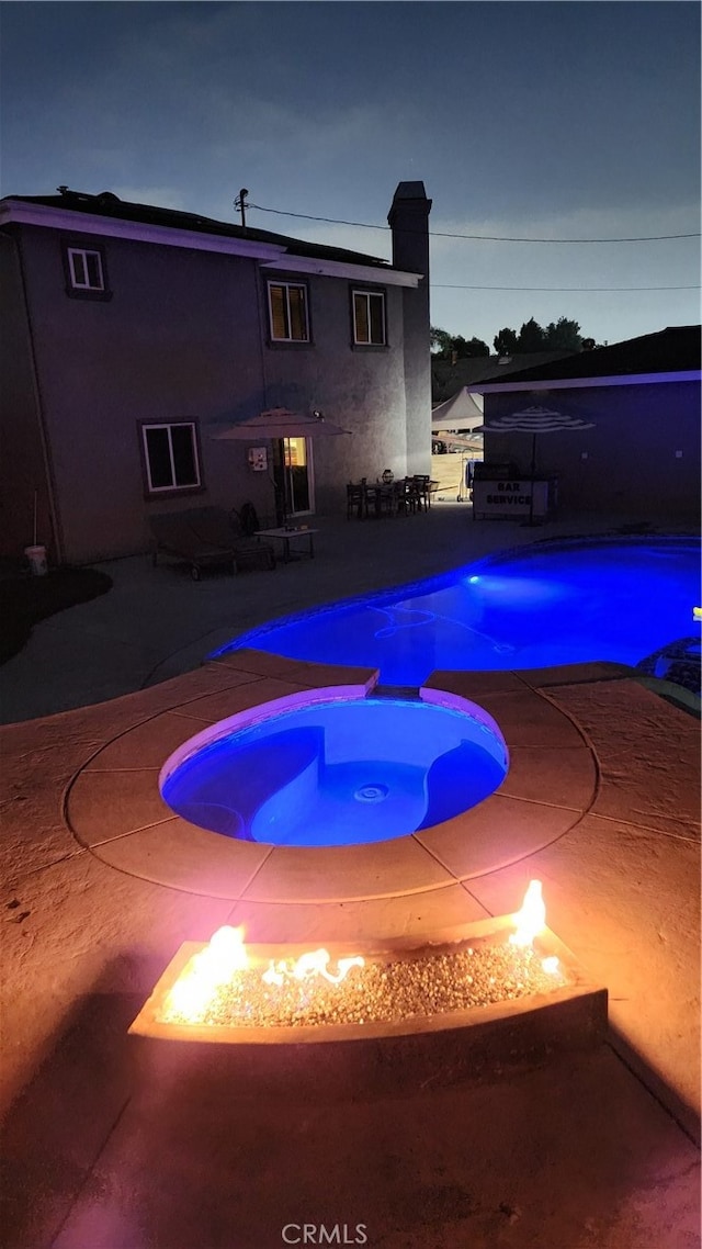 view of swimming pool with an in ground hot tub and a patio area