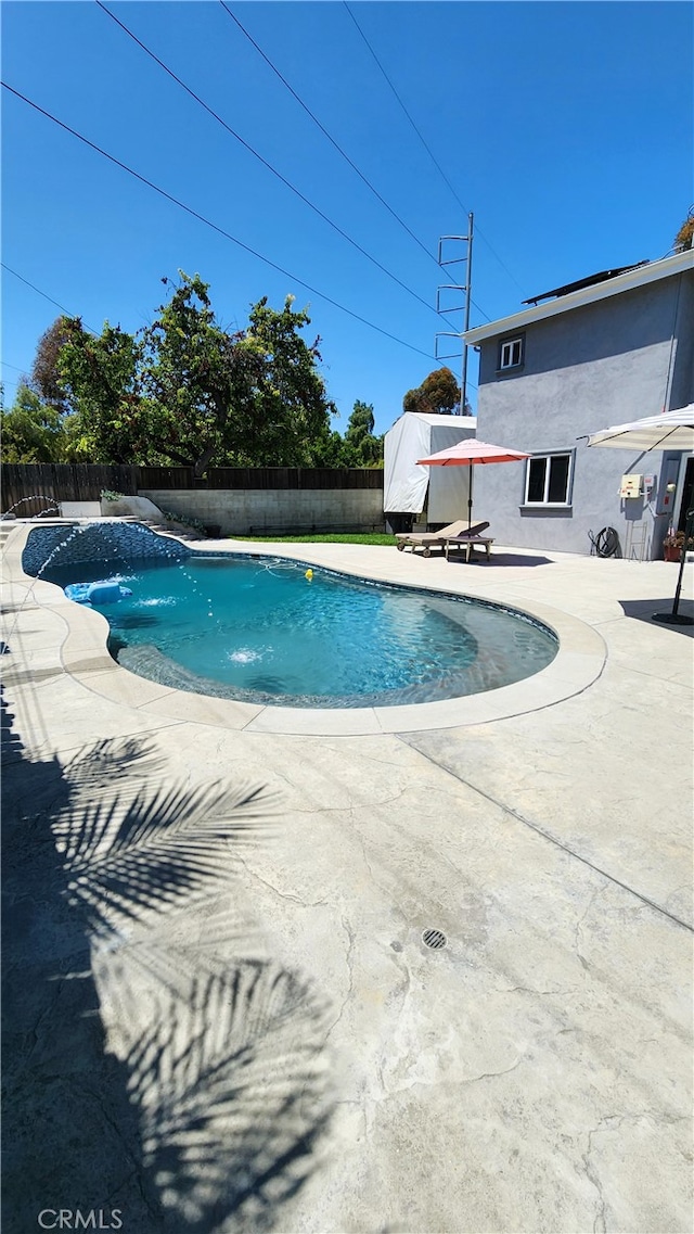 view of pool with pool water feature and a patio area