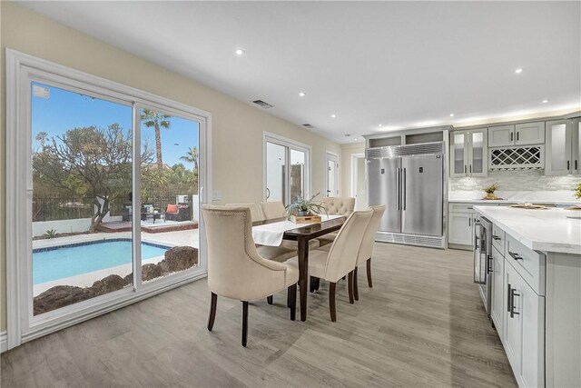 dining space with plenty of natural light and light wood-type flooring