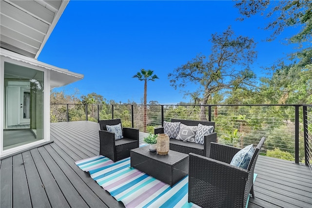 wooden terrace with an outdoor living space