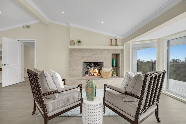 interior space featuring light hardwood / wood-style flooring, crown molding, and vaulted ceiling