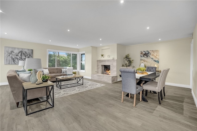 dining room with a fireplace and light hardwood / wood-style floors