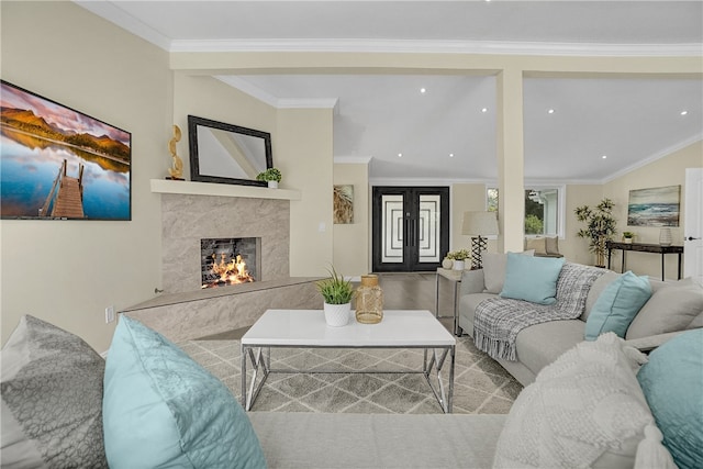 living room with french doors, crown molding, and a premium fireplace