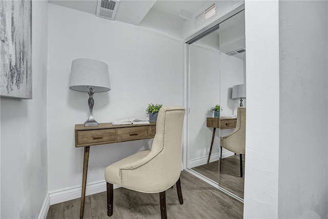 sitting room with built in desk and hardwood / wood-style flooring