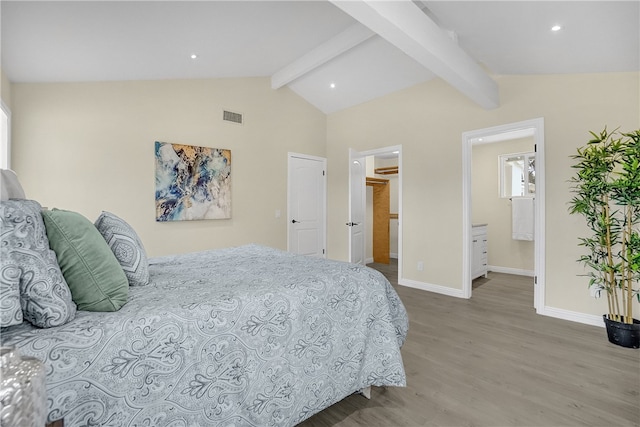 bedroom featuring ensuite bathroom, lofted ceiling with beams, and light hardwood / wood-style flooring