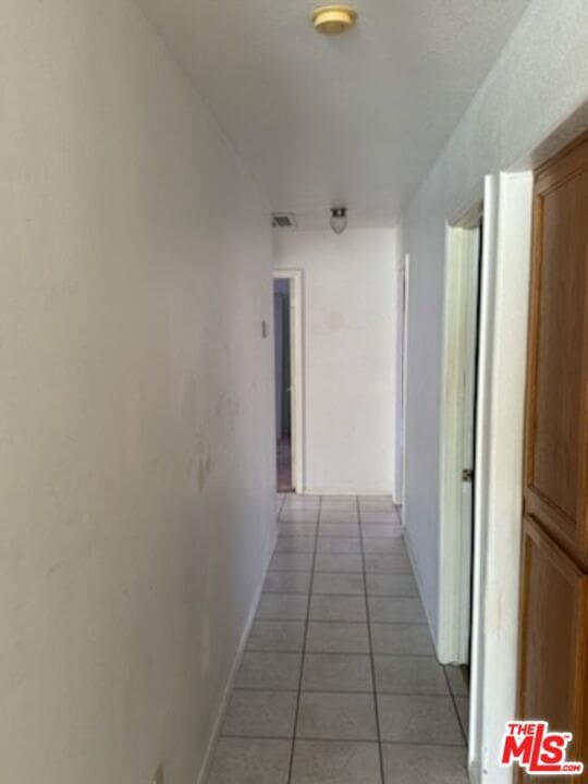 hallway with light tile patterned flooring