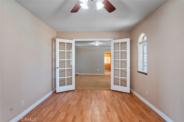 unfurnished room with french doors, light hardwood / wood-style flooring, and ceiling fan