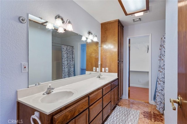 bathroom featuring a shower with shower curtain, vanity, and tile patterned floors