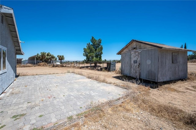 view of yard with a patio area and a storage unit