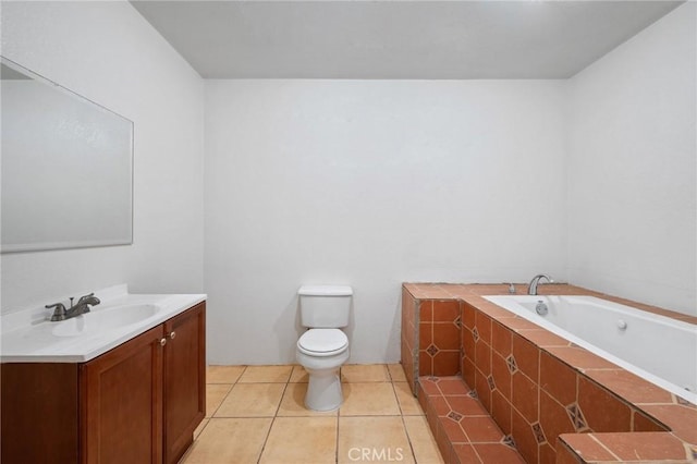 bathroom with tiled bath, tile patterned flooring, vanity, and toilet